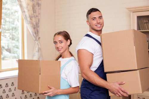 Professional movers carrying furniture for a local move in South Croydon